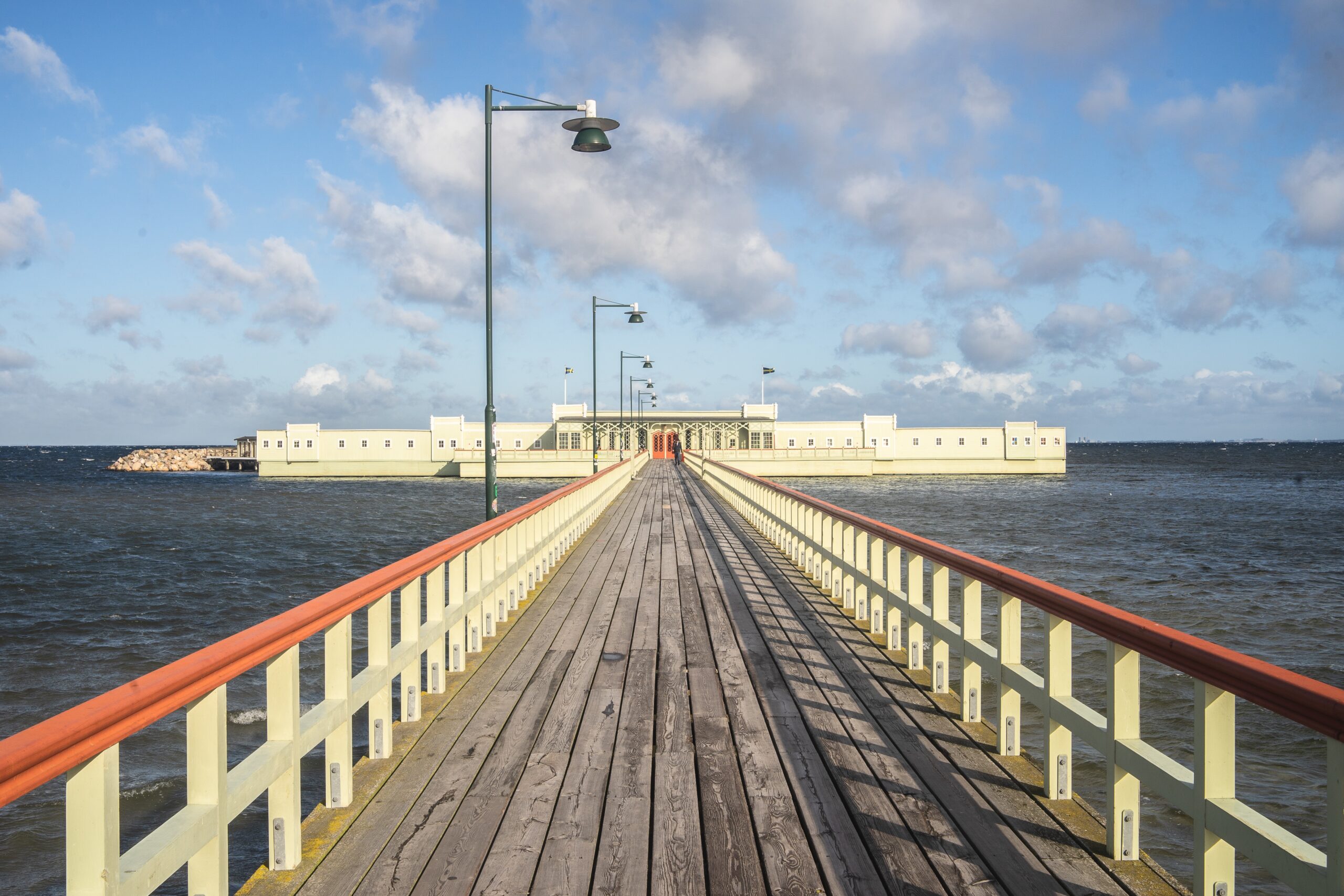 Pier surrounded by the sea and buildings under a cloudy sky at Asbury Park New Jersey boardwalk