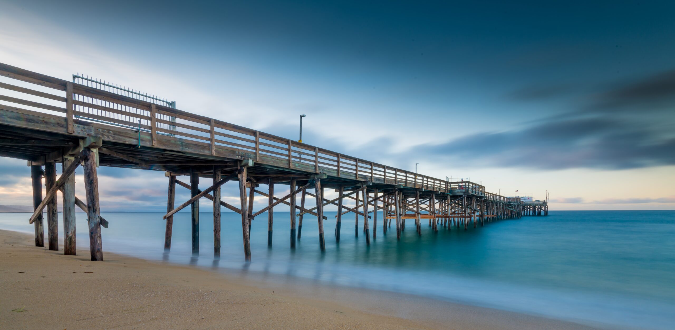 Long exposure shot of a pier on the Jersey Shore beach at sunset