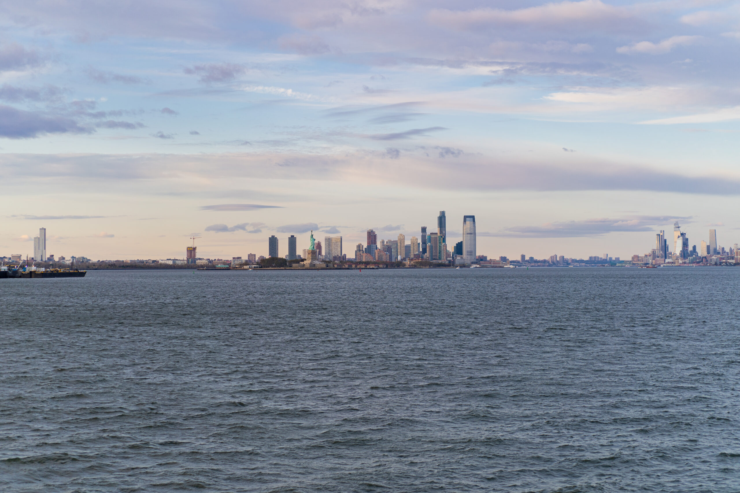 Ferry to Manhattan with NYC skyline at sunset