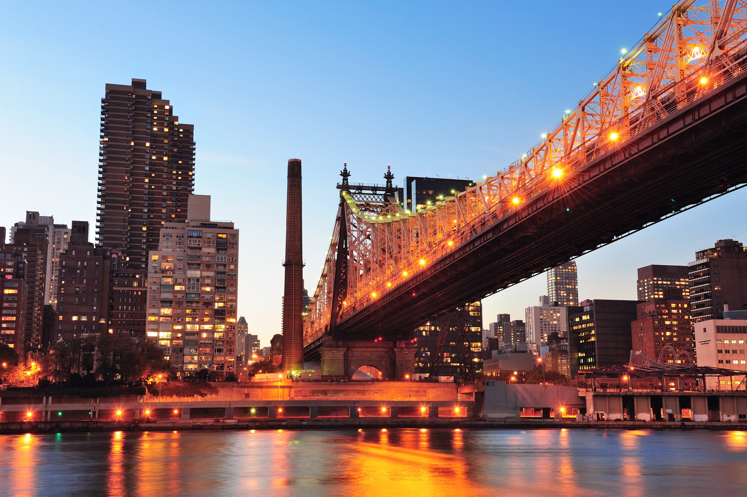 Queensboro Bridge over the East River at sunset with Manhattan skyline
