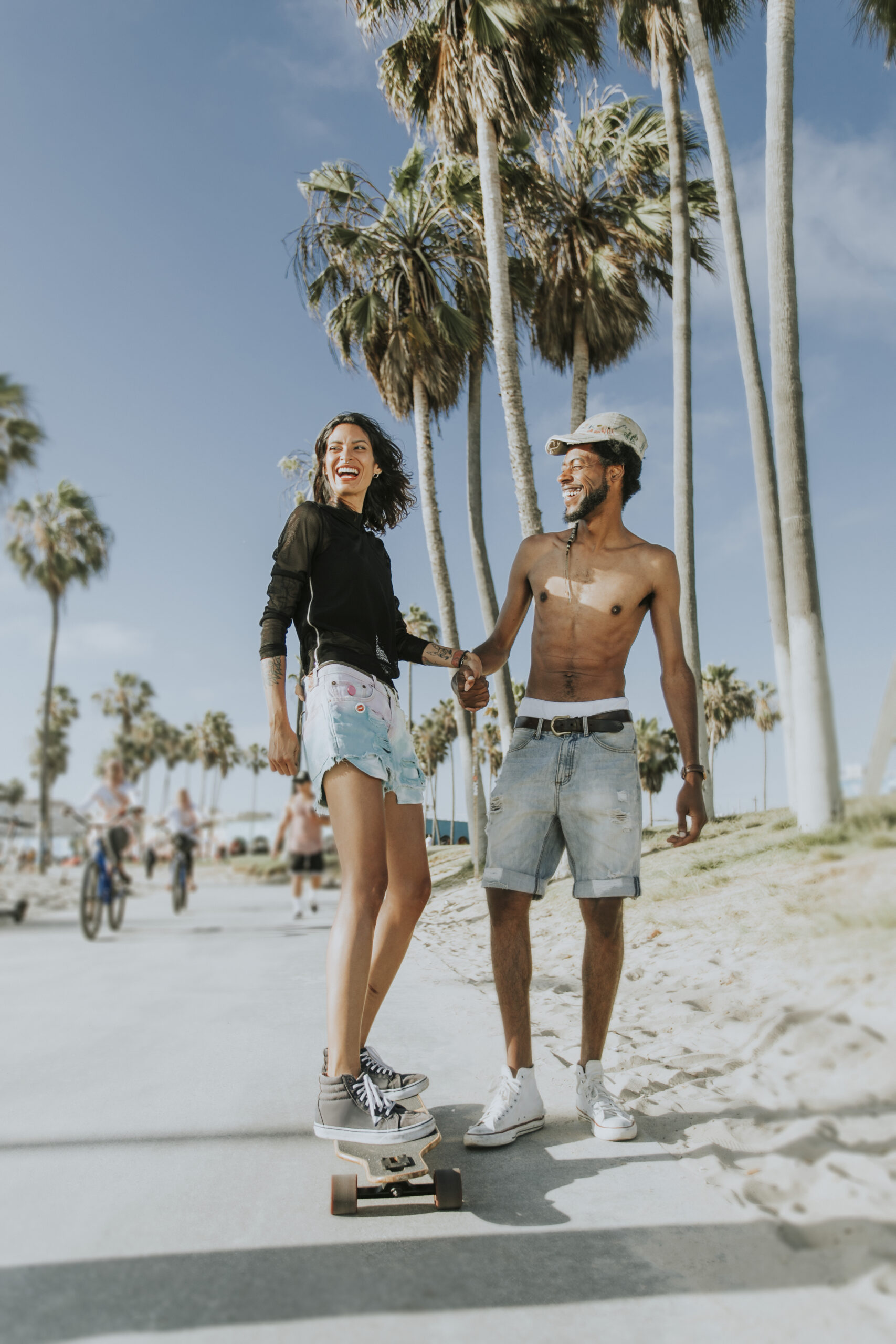 Couple longboarding at Venice Beach Los Angeles California