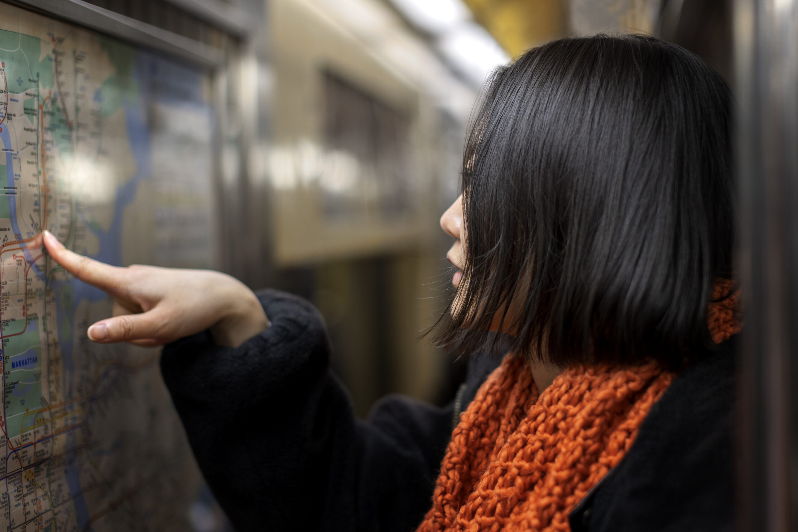 Woman checking map on the New York City subway